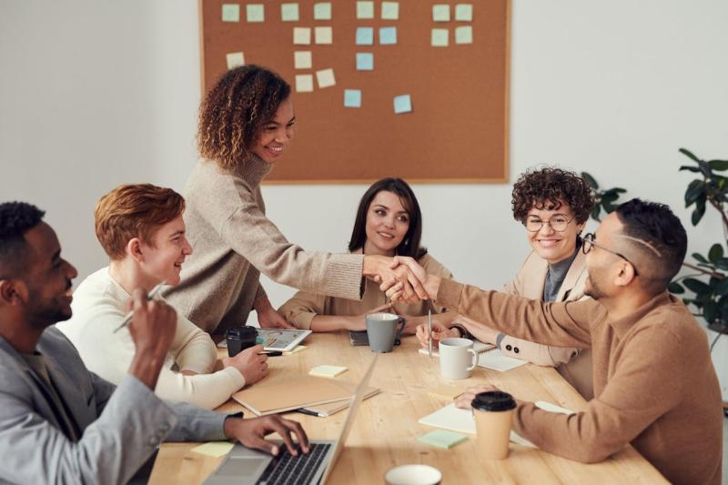 A diverse group of independent professionals collaborating together around a table