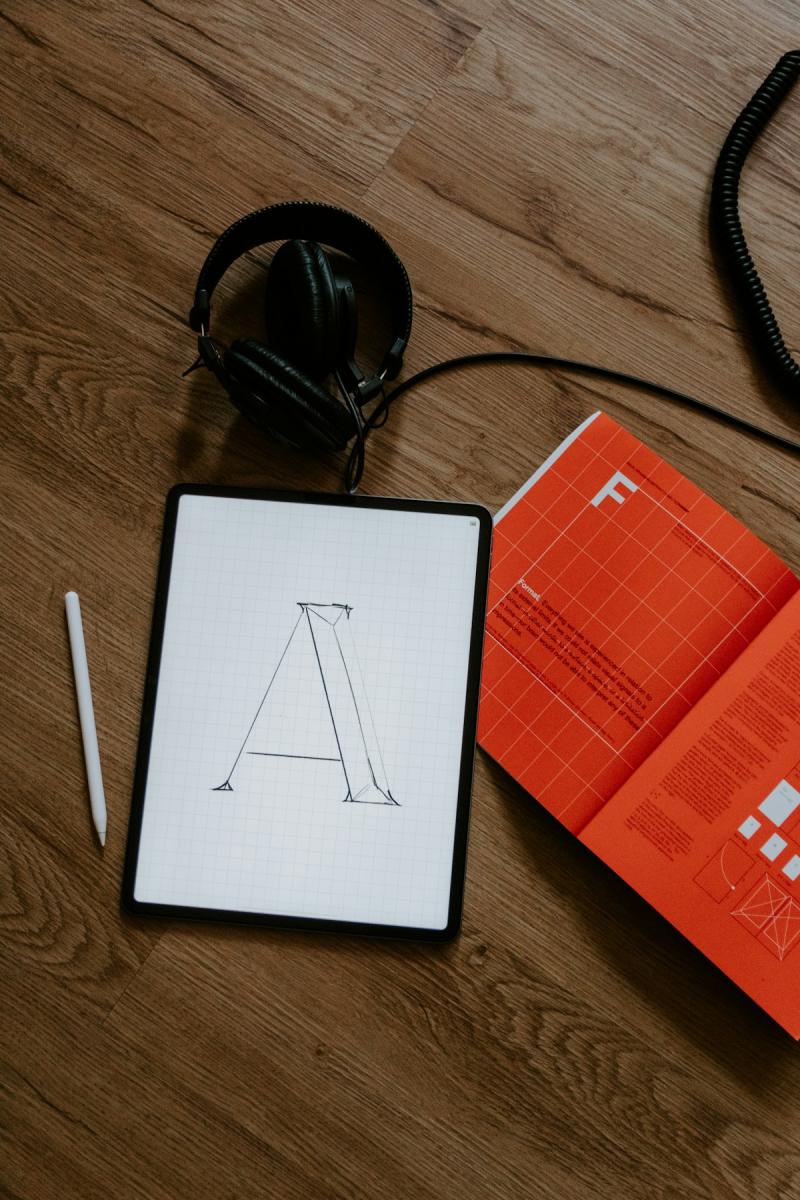 Professional workspace with a notebook and laptop showing a portfolio website